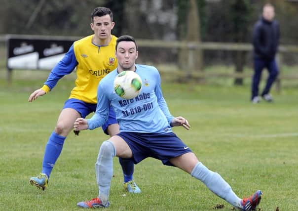 Ards Rangers' Daryll Kernohan shields the ball from Nortel's Owen Thompson. Photo: Philip McCloy