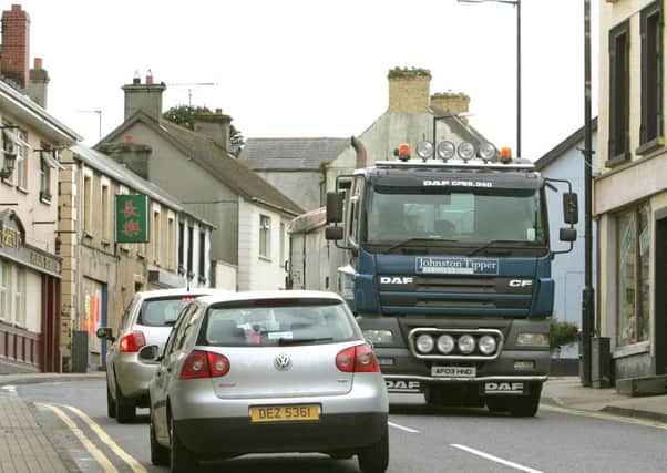 Traffic passing through the bottom of Main Street in Dungiven. LV43-719MML