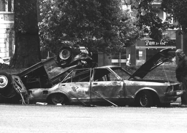Police forensic officers working on the remains of the IRA car which housed the Hyde Park car bomb.