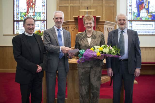 Local lady Linda Elliott is pictured being presented with a bouquet of flowers after 39 years as organist with Bushmills Presbyterian Church. Included are Minister Rev. Noel McLean, Elder Alec Twaddle and Elder Raymond Freeman. INBM10-14F