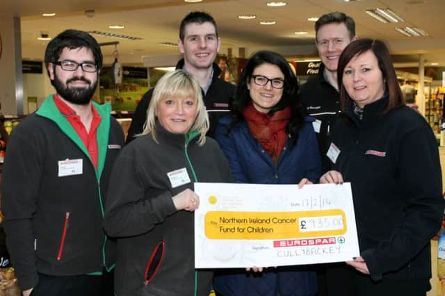 Sorcha Chipperfield, from the Northern Ireland Cancer Fund for Children, is pictured receiving a cheque for £935 from the staff at Eurospar Cullybackey who raised the money from quiz night, organised by Paul Patterson (pictured left). Included are Pamela McMurray, David McFall, Jonathon Cameron and Laura McLean. INBT09-200AC