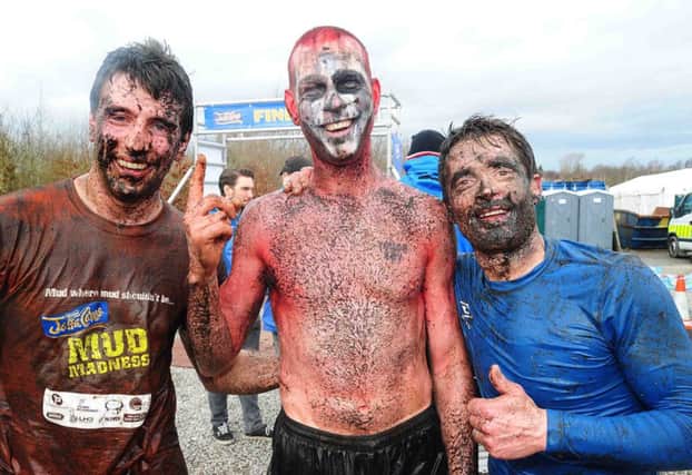 MUDDY MARVELLOUS: Winners of the first race (l-r) Nicky Toal (2nd Place) from Banbridge, Keith Clarke (1st Place) and Joe McCord (3rd Place) both from Dungannon celebrate after they completed last years McVities Jaffa Cakes Mud Madness race. Hundreds of competitors have already signed up to get down and dirty for charity at the muckiest event in Northern Ireland which will be taking place on Sunday April 13 at Foymore Lodge in Portadown.  Competitors will run, crawl and belly-flop their way across four and half miles of bogs and ponds, under cargo nets and through water sprays and muddy trenches and those taking part in the wacky race are being encouraged to raise funds for Marie Curie Cancer Care, charity partner for event.  For further information go to www.jaffacakesmudmadness.com.