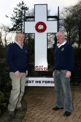 Willie Simpson and Robin Murray with the 1914 commemoration cross at the Memorial Garden in Randalstown. INAT10-407AC