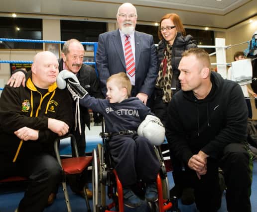 CHARITIES FIGHT. Mickey Fleming of Churchlands Golden Gloves, Alan 'Spike' Martin, of Scorpion Boxing Club and Raymond Pollock (Children to Lapland Trust) launch their International Boxing Night in the Lodge Hotel on 4th April, in aid of Davy Boyle the Caring Caretakers Charities and Wee Oliver Dickey. The clubs are jointly bringing a team from England to compete on the night. Also included is Oliver's Mum Charlene.CR7-113SC.