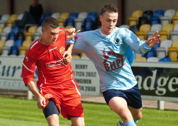 Institute's Darren McCauley battles to hold off Coagh United defender Scott McGeown. (DER3313KM003)