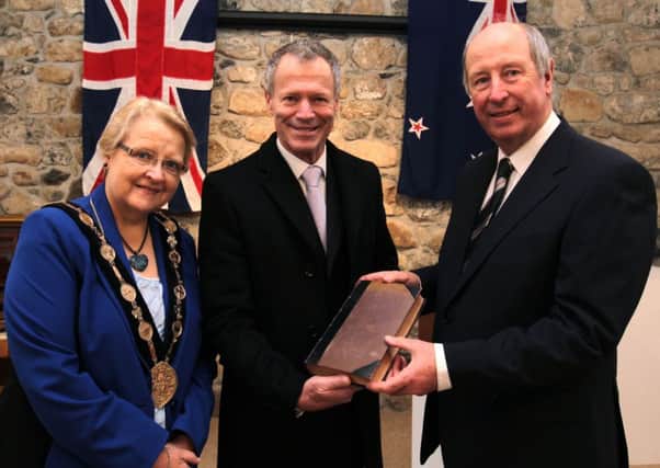 The New Zealand High Commissioner, Sir Lockwood Smith presents a Maori Dictionary to the Chairman of the Ulster New Zealand Trust, Mr Paul Hewitt in the presence of Lisburn City Council Mayor, Councillor Margaret Tolerton during his visit to The Ballance House.