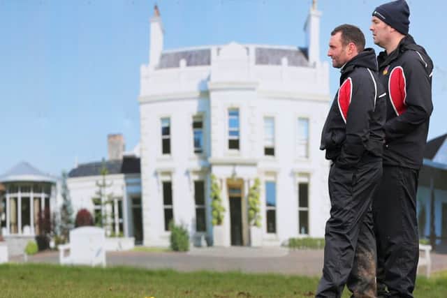 Ballymena Head Coach Andy Graham (right) and his assistant Nick Wells appear to be standing on the front lawn of Galgorm Resort as a photograph of the club's sponsor forms a backdrop at Eaton Park during Saturday's win over Seapoint. Picture: John McIlwaine (Press Eye).
