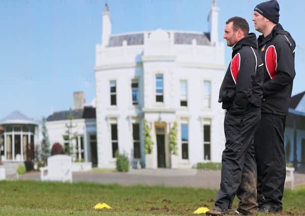 Ballymena Head Coach Andy Graham (right) and his assistant Nick Wells appear to be standing on the front lawn of Galgorm Resort as a photograph of the club's sponsor forms a backdrop at Eaton Park during Saturday's win over Seapoint. Picture: John McIlwaine (Press Eye).