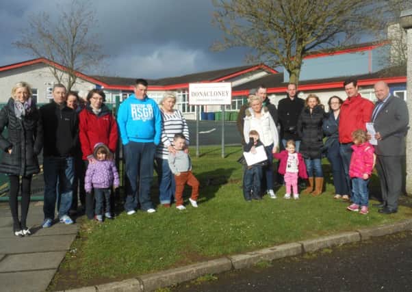 Cllrs Mark Baxter and Carla Lockhart with parents at Donacloney Primary School.
