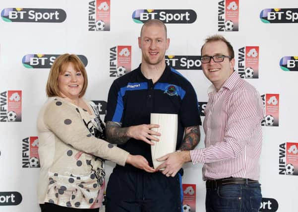 Institute's Stephen O'Flynn receives his NIFWA Championship Player of the Month trophy from Maria McMullan, BT Head of Consumer Sales in Northern Ireland and Paul Ferguson, chairman of the Football Writers.