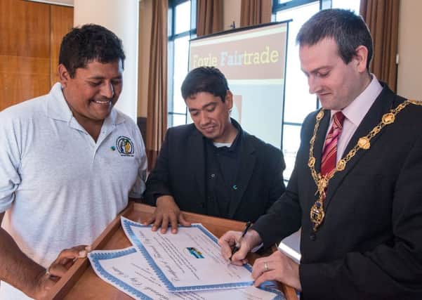 The Mayor Councillor Martin Reilly,  pictured at the announcement, that Derry has become a Fairtrade City with from left, Alfredo Ortego, from Belize and Alex Flores, El Salvador. Picture Martin McKeown. 03.03.14