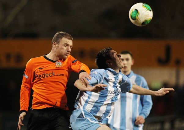 Warrenpoint's Stephen McCabe and Glenavon's Andy Kilmartin in action on Tuesday night.