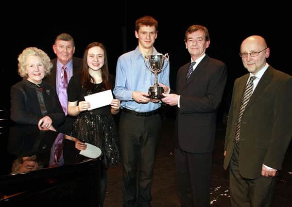 Brian Beggs, of Beggs and Partners, presents the Young Instrumentalist of the Year award at the Braid Arts Centre to winner Cormac O'Briain watched by Irene Cumming, Stanley Hughes, Rebecca Doherty (runner-up) and Donal McCrisken. INBT 09-933H