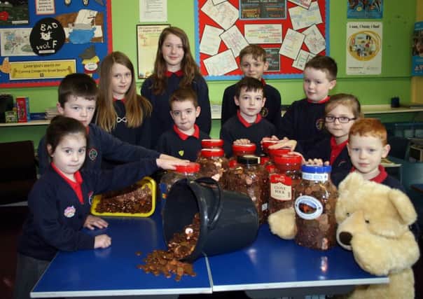 Members of the School Council at Landhead P.S. with the amazing amount of coppers collected as part of a collection for two charities.INBM11-14 101LMM.