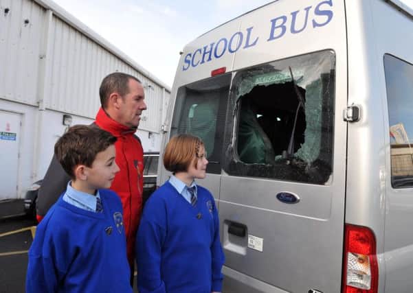 Anthony McMorrow, principal of St Francis' Primary School, Oran McCafferty, head boy and Lydia Quine, head girl look at the damage to their school mini bus. INLM10-105gc