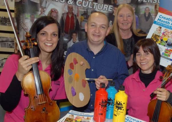 Mireia Ferrer and Claire Blake from the Ulster Orchestra along with John Paul Russell and Annie Armstrong from Colin Neighbourhood Partnership help launch the Creativity Month in Colin. INUS0814-COLIN