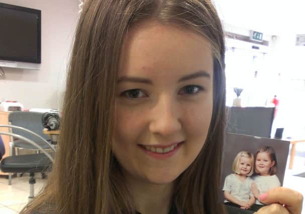 Emma Smallwoods with a photograph of herself and younger sister Loren, when they were little and cut each other's hair. That was the last time Emma had short hair, until now...