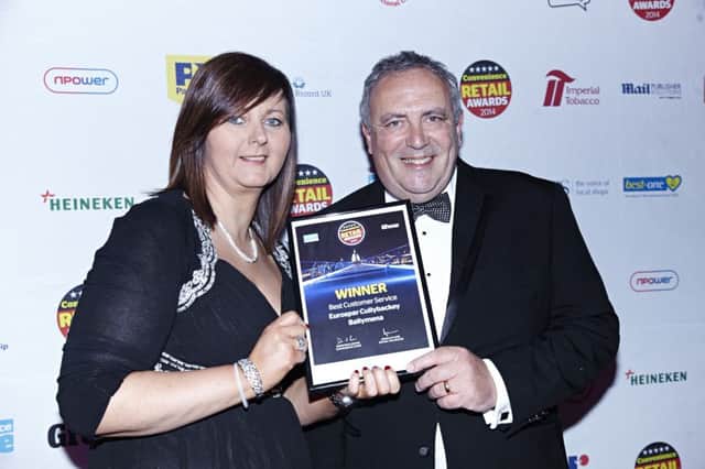 Store manager Laura McLean celebrates with Bestway symbol group director James Hall