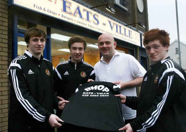 Carniny U-16 members Tyrone Balmer, Matthew Shevlin and Adam Mairs with George McKay of Eats-Ville who presented new sponsored tracksuits to the team. INBT11-214AC