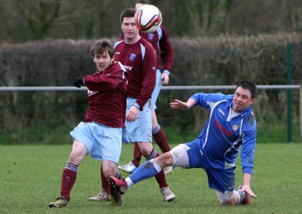 Raceviews Jason Stevenson slides in to try and stop the cross of Holywell's John McCleary. INBT11-239AC