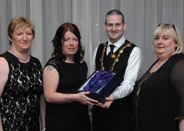 The Mayor of Derry Colr. Martin Reilly presents the Women of the Year 2014 award to Jacqueline Williamson of Kinship Care with Joanna Boyd, left, Derry City Council women's officer, and Catherine Cooke, Foyle Women's Information Network. (DER1014PG030)