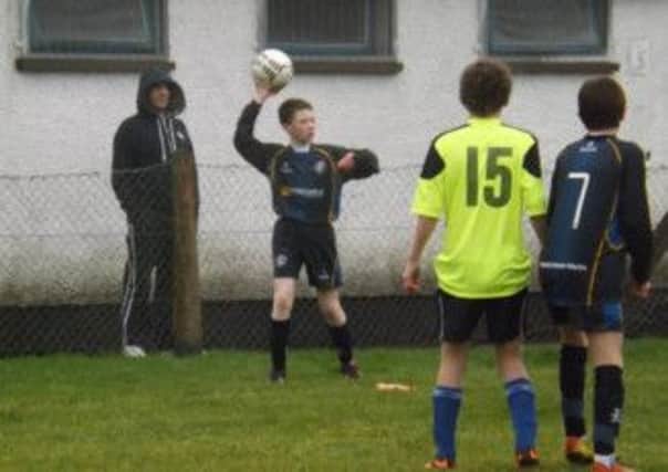 Jack Turkington prepares to throw the ball in for Cookstown Youth U14.