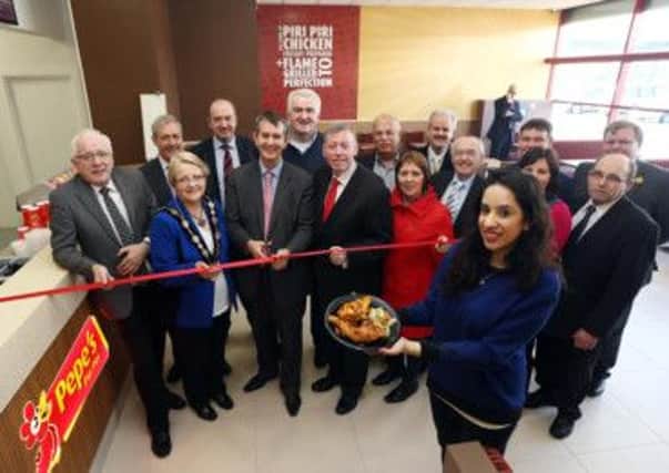 Mr Rashmi Chatwani (centre) and daughter, Leena, at Pepe's Piri Piri, which opened in Lisburn Leisure Park last week, with Minister Poots MLA, the Mayor, Councillor Margaret Tolerton; Alderman Allan Ewart, Alderman Paul Porter, Councillor Jenny Palmer, Elected Members of Council and invited guests who joined in the official opening.