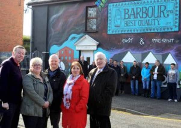 Pictured at the Hilden Mural to mark the completion of the partnership improvement scheme are (l-r) Alderman Paul Porter, Chairman of the Council's Leisure Services Committee; Trish McCormick, Philip Dean, Councillor Jenny Palmer; Alderman Allan Ewart, Chairman of the Council's Economic Development Committee and community members in the area.