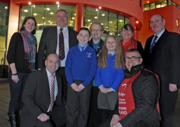 Pictured at Lagan Valley Island which was lit up red to support the British Heart Foundation are members of St Colman's  Primary School; Councillor Pat Catney, Chairman of the Council's Corporate Services Committee; the Mayor of Lisburn, Councillor Margaret Tolerton; Alderman William Leathem and Gary Wilson, British Heart Foundation.