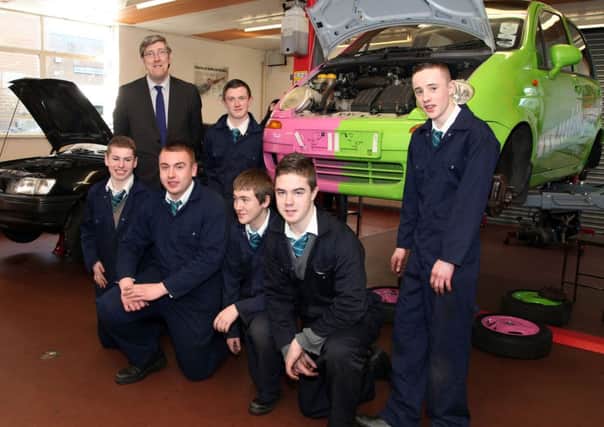 John O'Dowd MLA Minister of Education who officially opened the Art and Design Centre at St. Joseph's College on Wednesday meeting pupils from North Coast Integrated College in the car mechanics garage at St. Joesph's. INCR12-126PL