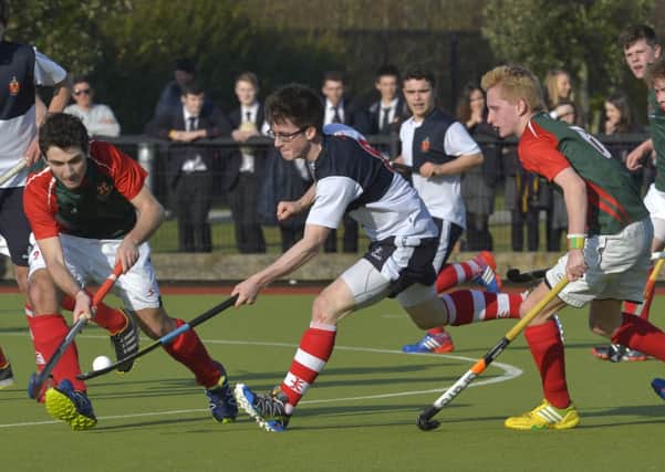 Mandatory Credit: ROWLAND WHITE / PRESSEYE
Hockey: Burney Cup Semi-Final
Teams: Wallace HS (blue/white) v Friends (green/red)
Venue: Lisnagarvey
Date: 12th March 2014
Caption: Jack Wilson of Wallace trying to force his way through the Friends defence