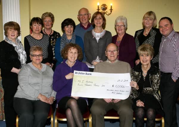 Siofra Healy (seated second left), from the Northern Ireland Hospice, is pictured receiving a cheque for £60,000 from Ballymena Branch Treasurer Jim McGookin, money raised from last years fundraising. Included is branch chairman Helen Knox and committee members. INBT12-213AC