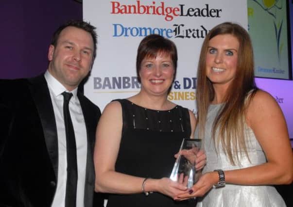 Michael and Sarah Callen present the Best Retailer award at the Banbridge District Business Awards to Roisin McAleenan from Angelic Bridal. INBL1214-BUSAWARD43