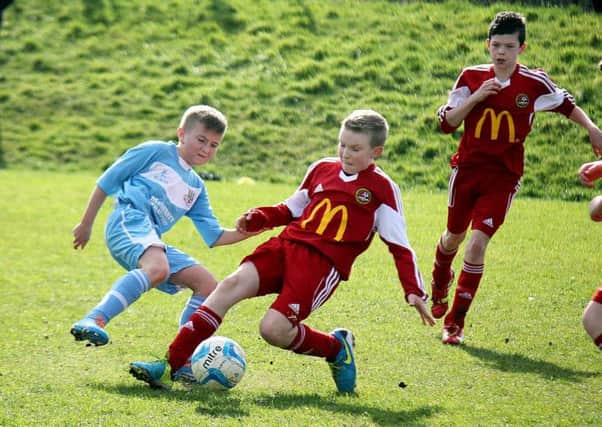 Hard-tackling action during Saturday's under-13 clash between Carniny Youth and Ballymena United. INBT 12-925H