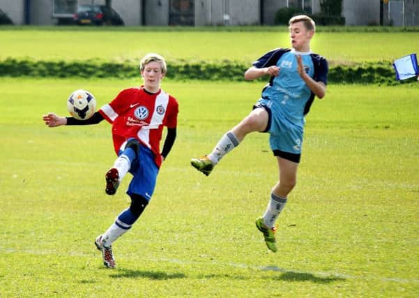 A Southside Youths player flicks the ball past an Immaculata opponent during Saturday's match at Wakehurst. INBT 12-902H