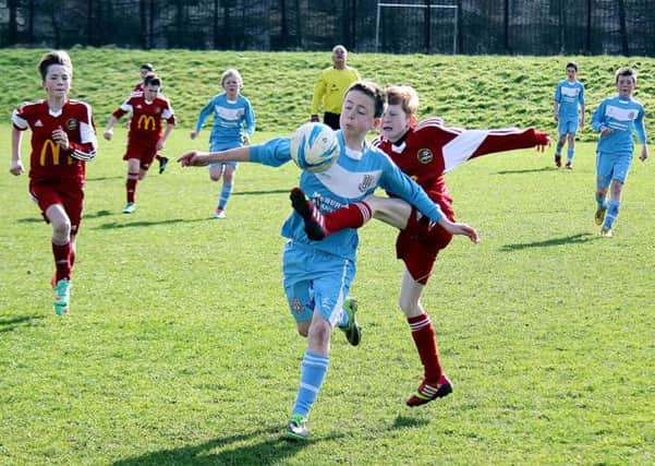 Ballymena United and Carniny Youth under-13 players attempt to get a difficult bouncing ball under control. INBT 12-922H