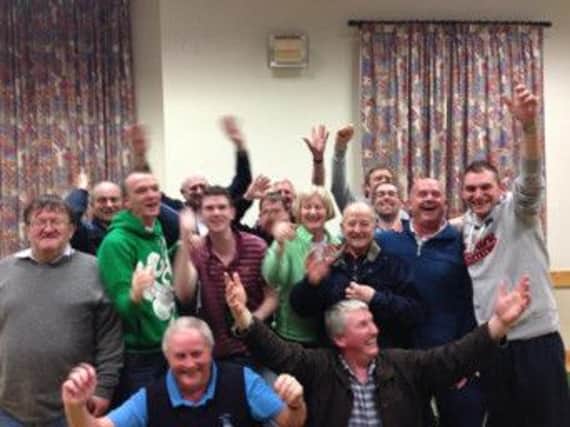 St Colman's players celebrate winning the league title last week.