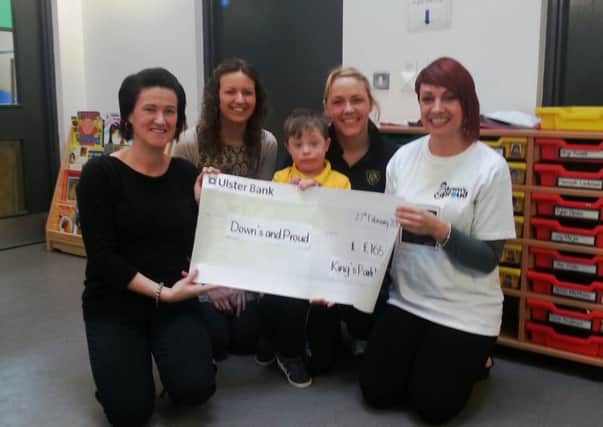 King's Park Nursery School have raised £330 for local charities by making donations in lieu of presents at Christmas. Half of the money, £165 was presented to local charity, Down's and Proud. Receiving the cheque on behalf of Down's and Proud is Ruth Russell. Also pictured is her son Rhys.