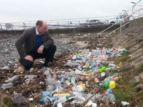 East Antrim MLA Roy Beggs at Fisherman's Quay before the build-up of litter and plastic bottles was removed by Carrickfergus Council. INCT 12-794-CON