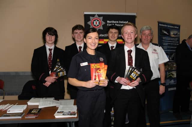 Carrickfergus Grammar School students Jack Hendry, Rob McCormick, George Stokes and Philip McCullough with NI Fire and Rescue Service firefighter Rachael Garrett at the Amphitheatre  INCT 12-210-AM  careers