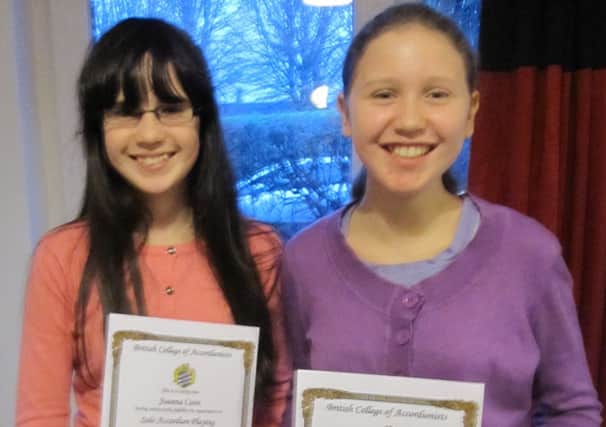 Joanna and Susanna Coon, from Millbrook, with their certificates for distinction in grade one and preliminary. INLT 12-658-CON