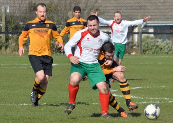Larne Tech's Sean Ward gets to grips with his Barn United opponent during Saturday's 3-3 draw. Photo: Philip Byrne