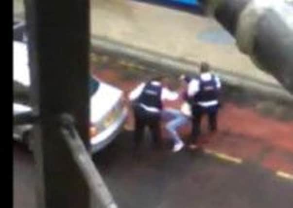 A still from the video posted online showing PSNI officers leaving the woman in a bus lane.