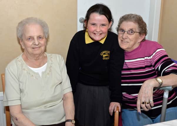Larne and Inver Primary School pupil, Megan McCaughey is pictured with Iris McCourt (left) and Meta Shaw at the afternoon tea in Lisgarel to celebrate Nutritional and Hydration Day. INLT 13-012-PSB