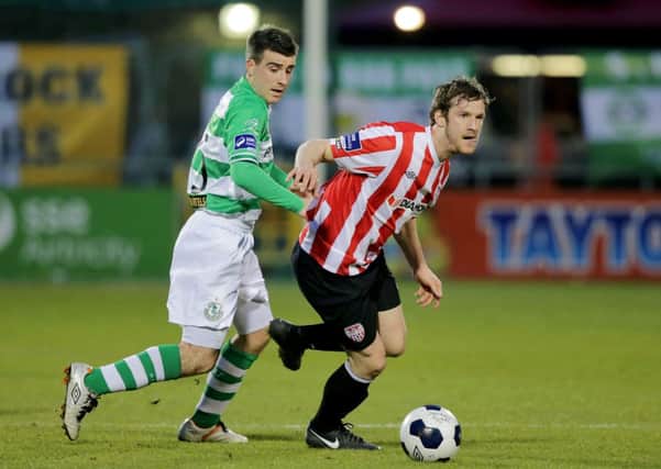 Derry City's Ryan McBride, who is pictured holding off Shamrock Rovers' Robert Bayly, is doubtful for tomorrow night's game at United Park.