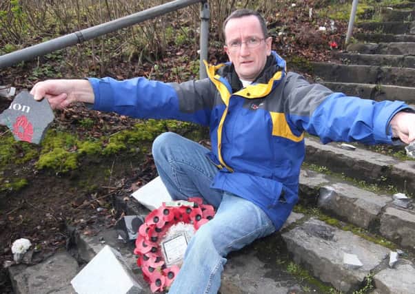 Councillor George Duddy of the DUP with parts of a broken memorial tablet which was smashed to peices in an overnight attack at Killowen Orange in Coleraine on Saturday morning. This was the second attack in recent months.PICTURE MARK JAMIESON.
