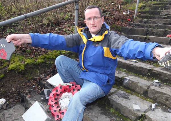 Councillor George Duddy of the DUP with parts of a broken memorial tablet which was smashed to peices in an overnight attack at Killowen Orange in Coleraine on Saturday morning. This was the second attack in recent months.PICTURE MARK JAMIESON.