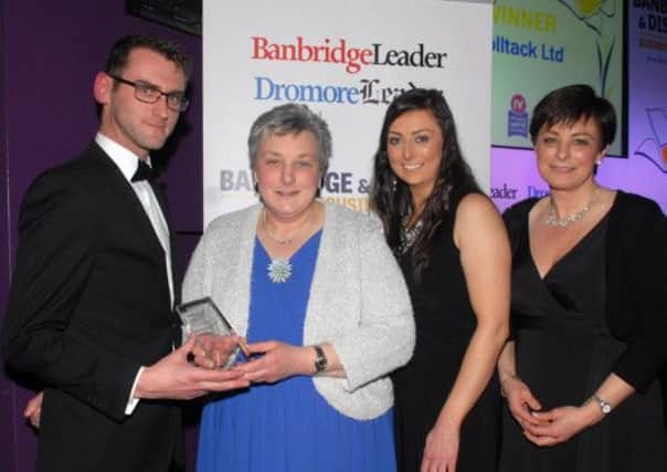 Giles Conlon from Iveagh Movie Studios, sponsors of the Best Entrepreneur award at the Banbridge District Business Awards presents the trophy to Rolltack representatives Claire Medland, Louise Medland and Anne Medland.  INBL1214-BUSAWARDS38