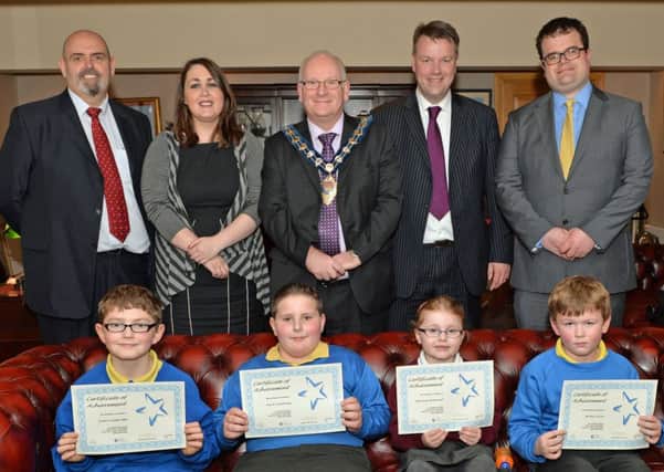 Receiving Certificates of Achievement as part of the Northlands Project are Sunnylands Primary School pupils Dylan Langridge, Mark Armstrong and Bailey Irvine, along with Ellie-Rose McDowell from Woodlawn Primary School. Inluded are (from left) Sam Martin from DSD; Claire Crawford, project worker; Mayor of Carrickfergus, Alderman Billy Ashe; Ian Mullen, principal of Woodlawn Primary School; and Gareth Hamilton, principal of Sunnylands Primary School. INCT 13-003-PSB