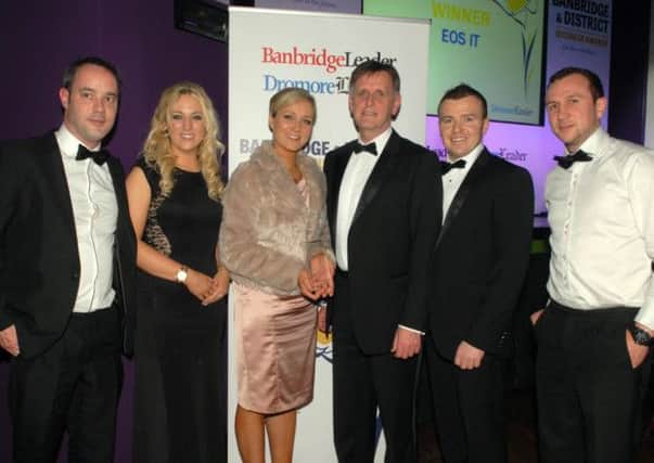 Mark Blakeny, Invest NI, sponsors of the Best Export Business Award at the Banbridge District Business Awards congratulates the team from EOS Unified Solutions including Mark Connolly, Cliona Malone, Adrian Strain, Sarah Moorehead and Conor O'Hagan.   INBL1214-BUSAWARDS42